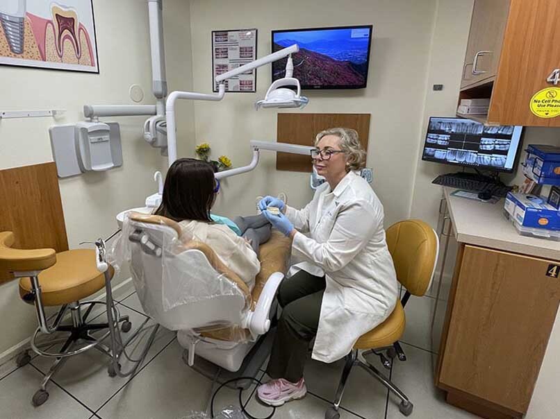 Atlas Park Dental dentist meeting with a patient during an initial consultation in Glendale Queens