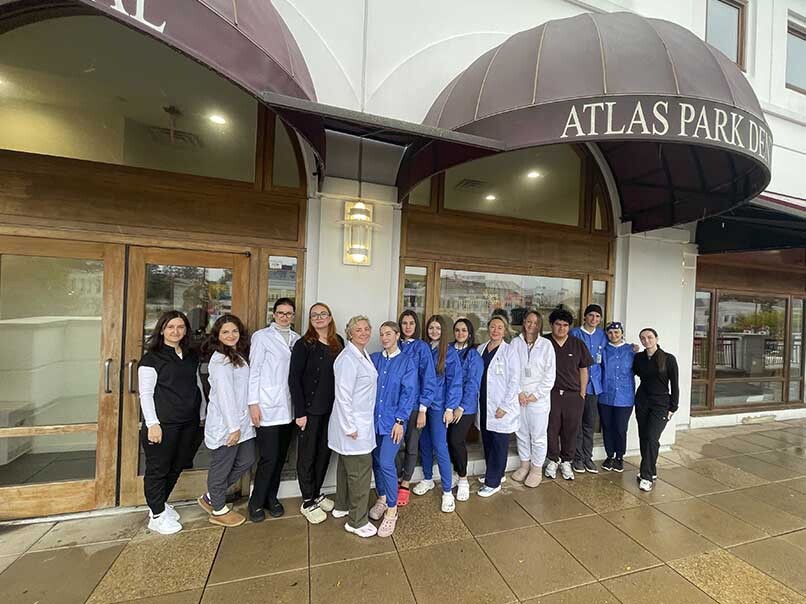 Atlas Park Dental team outside the Glendale Queens dental office welcoming new patients