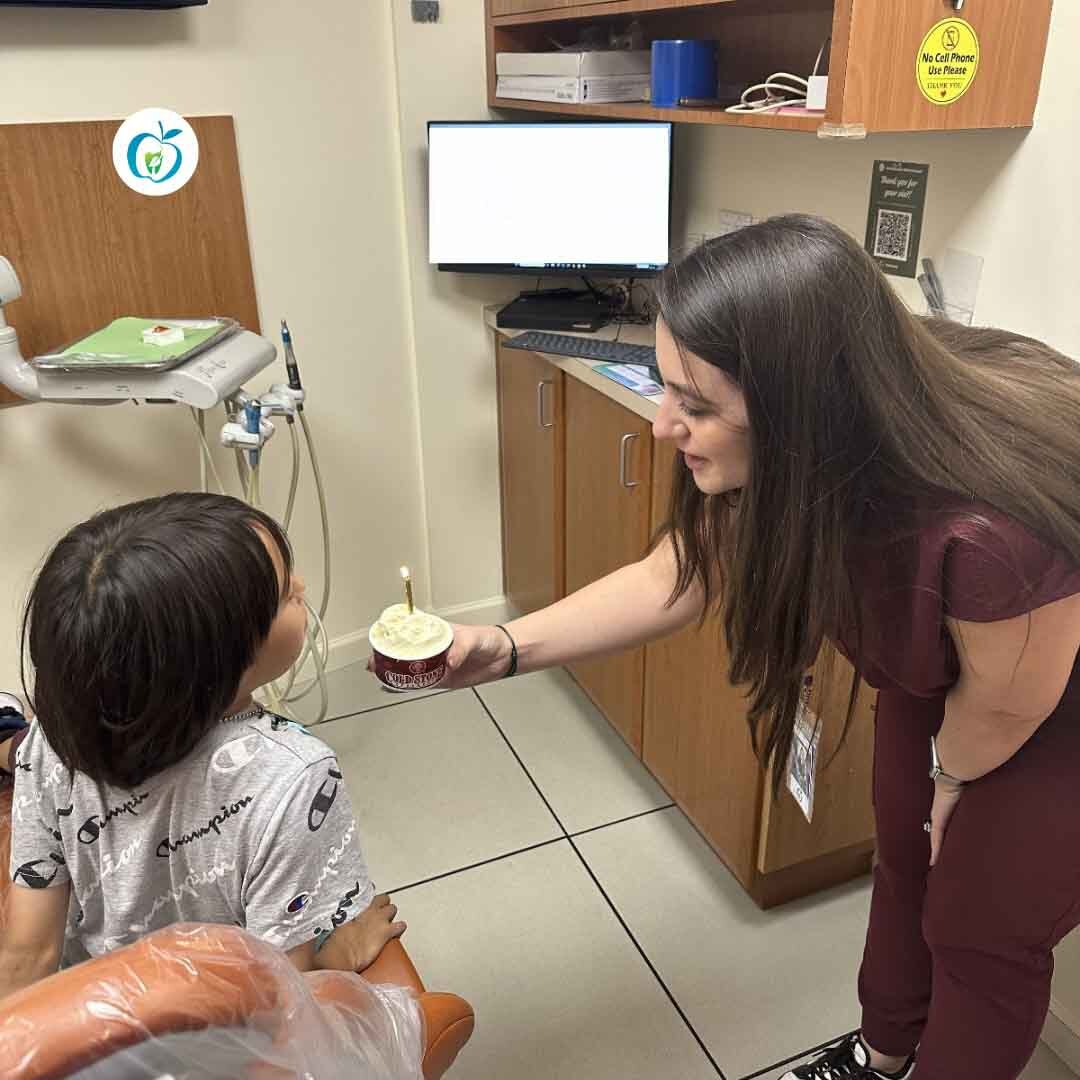 child at pediatric dentist sitting in dental chair during a routine dental visit
