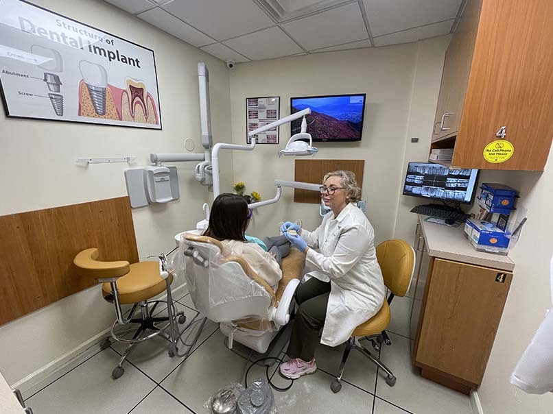 Dentist consulting with a patient during a preventive dental visit at Atlas Park Dental in Glendale, Queens
