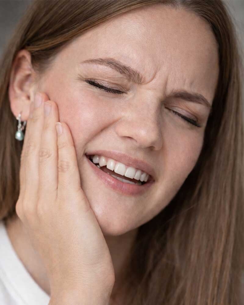 Patient experiencing facial pain caused by a tooth infection